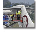 Photo of a Boeing 727-277 Associated Air Cargo undergoing repairs to its tail section