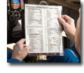 Photo of a pilot holding a checklist