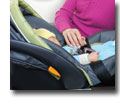 Photo of a baby in a secured child seat on an airplane
