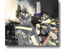 Photo of firefighters working to extinguish the fire at the site of the crash of Colgan Air Flight 3407 in Clarence Center, N.Y.on Feb. 13, 2009