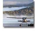 Photo of a landed waterplane in the foggy hills