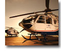 Photo of two EMS helicopters on the ground at sunset