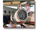 Photo of two mechanics working on an aircraft