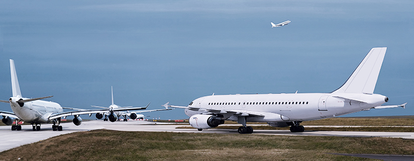 Airplanes lined up on runway.